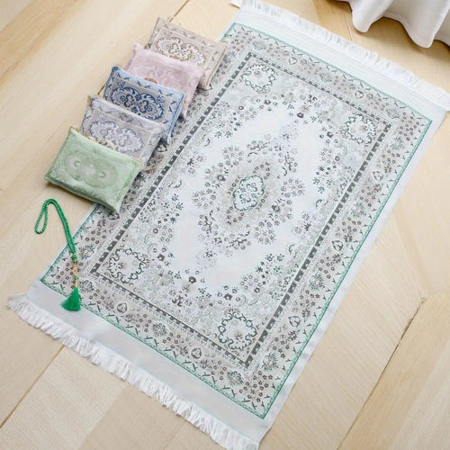 Prayer rug set with gray patterned mat, green border fringe, and small bead pouches
