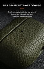 Close-up of dark green pebbled leather surface on an AirPods case