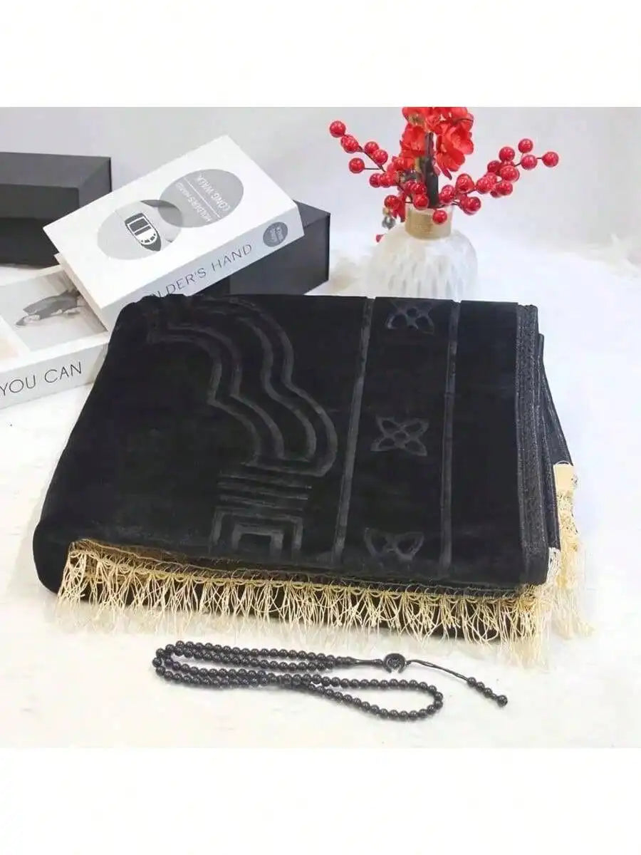 Velvet padded prayer rug in black with raised arch pattern and cream fringe trim, plus beads.