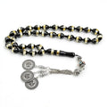 Prayer bead tasbih with black and gold striped beads and silver medallion charms
