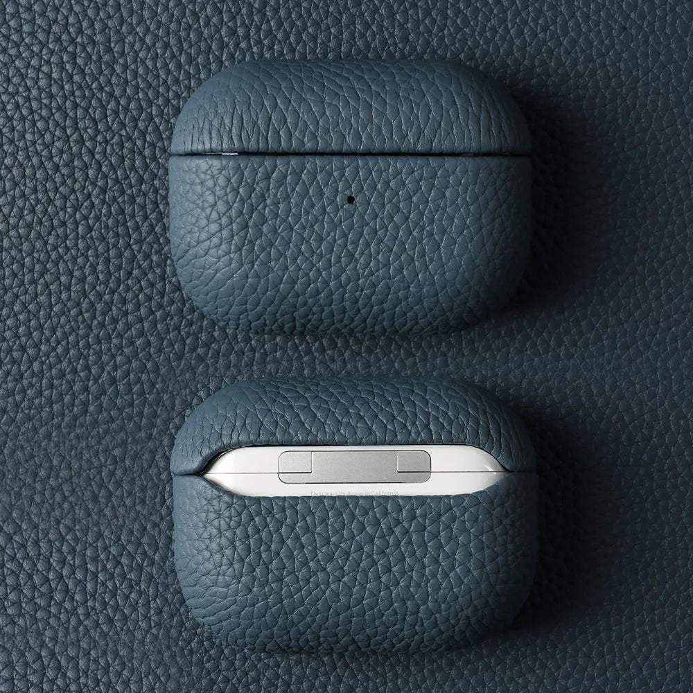 Sapphire Blue leather AirPods case, closed with pebble-grain texture on top lid