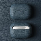 Sapphire Blue leather AirPods case, closed with pebble-grain texture on top lid