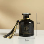 Reed diffuser 50ml bottle, 7 cm tall x 5 cm wide, dark glass with gold tassel