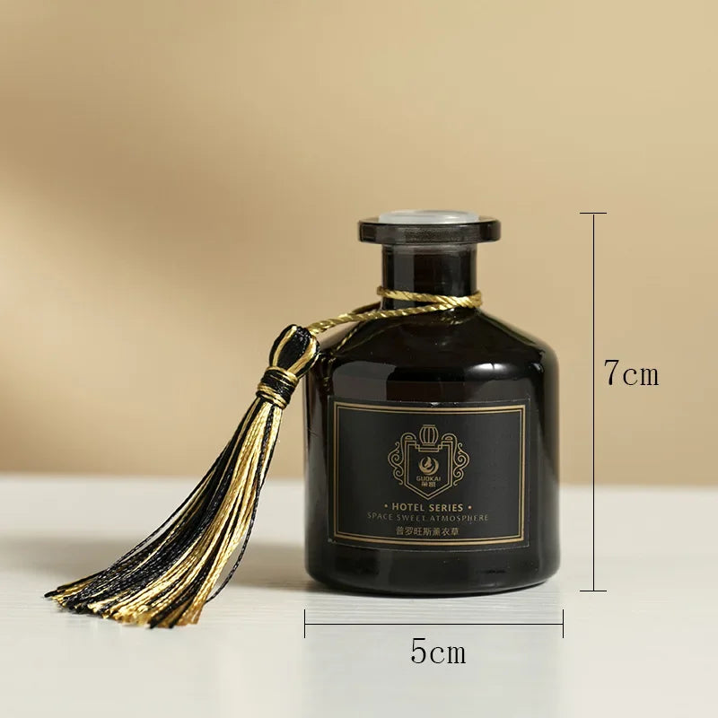 Reed diffuser 50ml bottle, 7 cm tall x 5 cm wide, dark glass with gold tassel