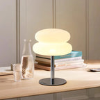 Mushroom USB ambient table lamp lit with warm white; stacked dome shade and chrome stand.