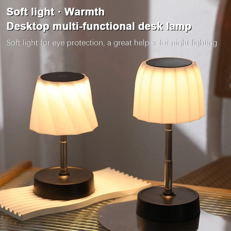 Cordless LED desk lamp, warm glowing white shade, black base, adjustable height