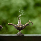 Aladdin Lamp incense burner with gold-tone details, pedestal base, smoke rising