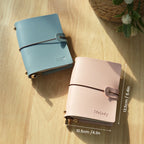 Light blue and ivory vegan leather passport holders with buckle strap and gold-tone hardware
