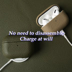 Khaki cowhide leather AirPods case open with white earbuds and charging cable