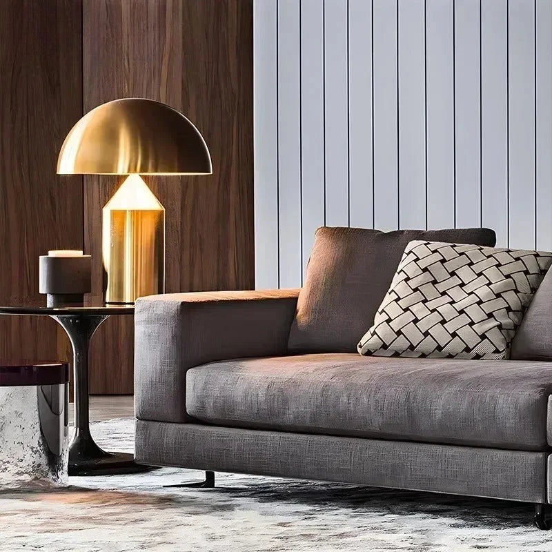 Gold-toned glass mushroom table lamp with arched shade and black metal base