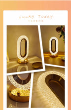Pearl white oval decorative lamp with gold base, angled close-up view