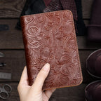 Cognac-brown leather travel folio, floral embossed surface, card pocket