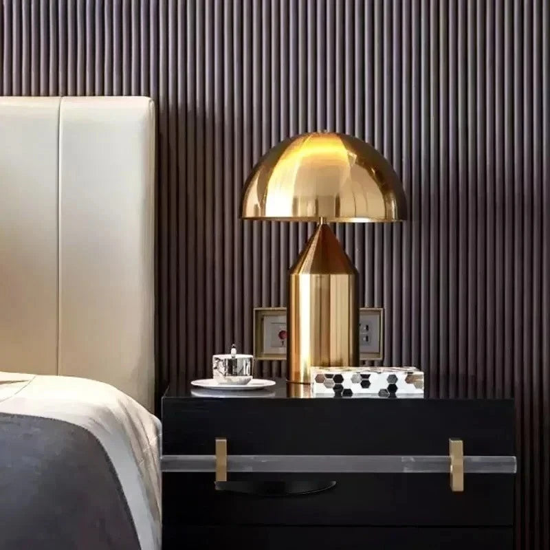 Brass/gold mushroom table lamp with dome shade and tall cylindrical glass body