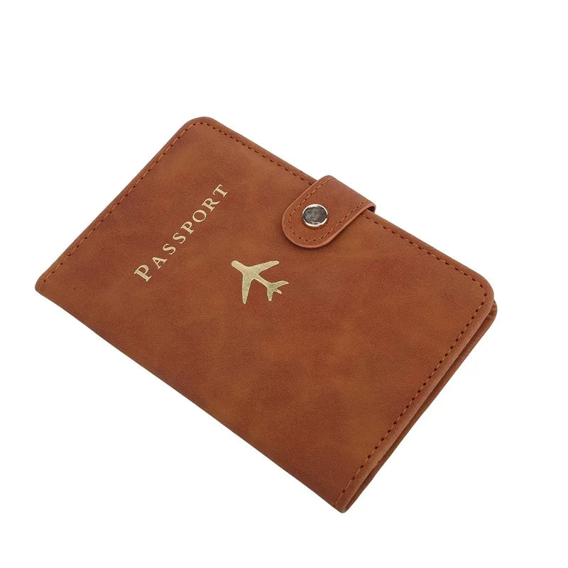 Cognac brown passport cover with airplane emblem and round metal snap