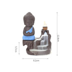 Backflow incense burner with blue-robed Buddha and stone incense cone