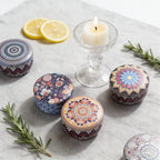 Tin candles with mandala lids and one lit candle, lemon-themed styling