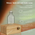 Essential oil diffuser with clear glass bottle and light wood base with brass knob