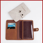 Cream/gray passport folio open view with airplane logo and inner card and passport pockets