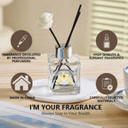 Reed diffuser bottle with black reeds, metallic top, and preserved flower label