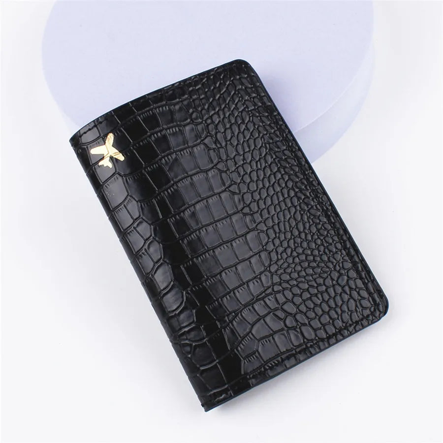 Lightweight travel passport sleeve, black croc-embossed leather look, gold airplane emblem