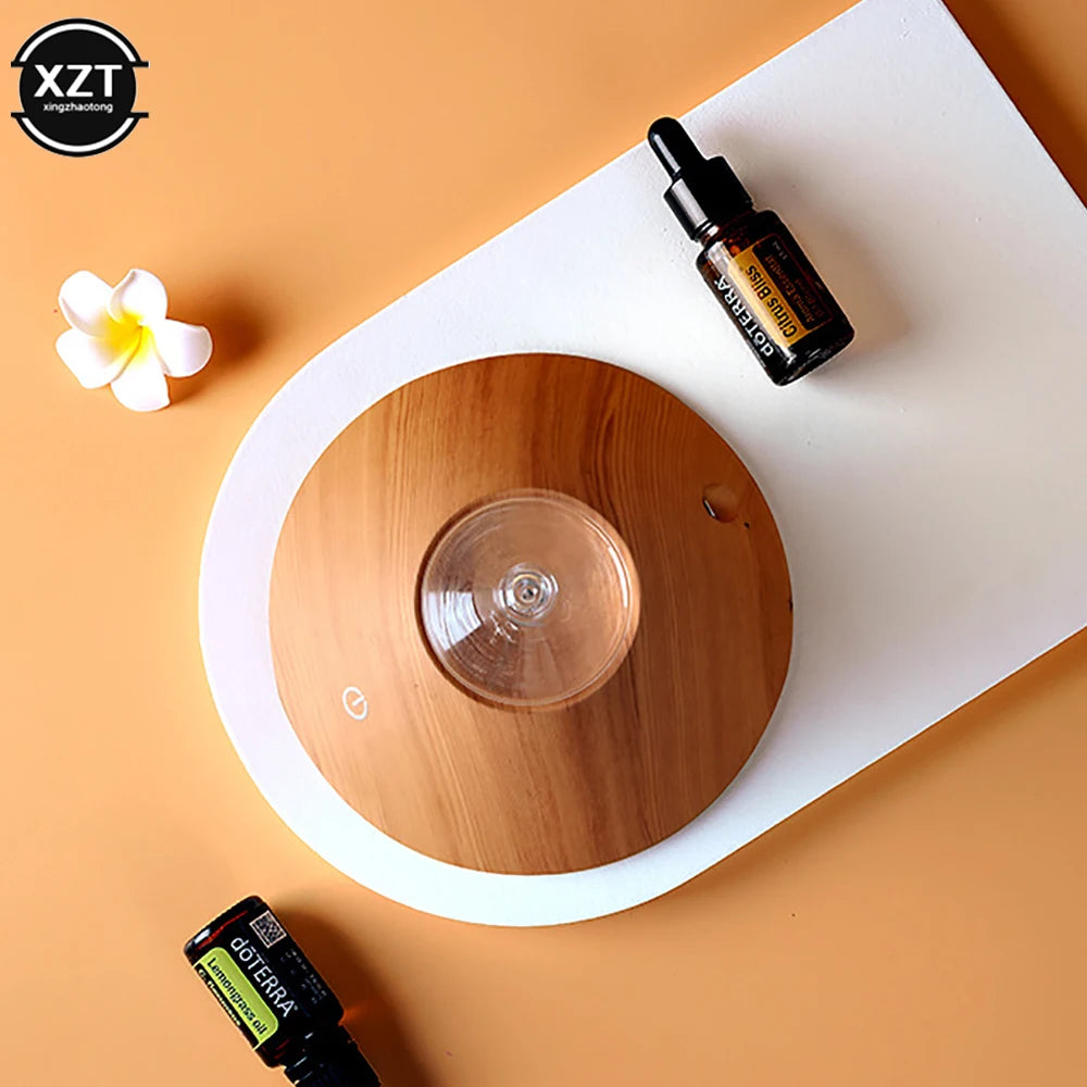 Wood grain aroma diffuser with clear top and white outer rim, power icon visible