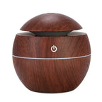 Dark wood grain air humidifier with domed lid and glowing power button