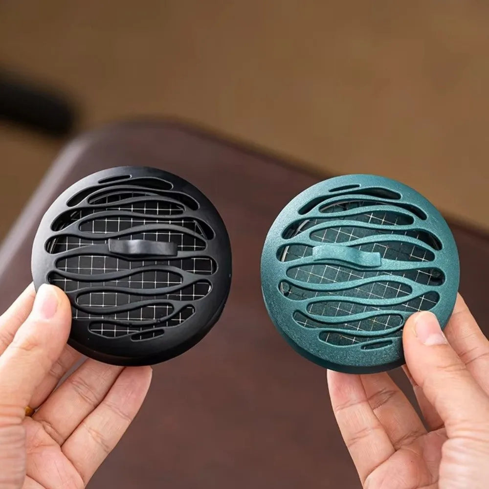 Black and blue incense burners side by side, round hollow vent pattern