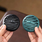 Black and blue incense burners side by side, round hollow vent pattern