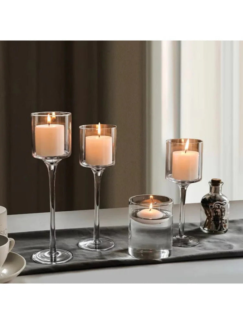 Set of 3 tall glass candle holders with unlit candles, transparent cup tops