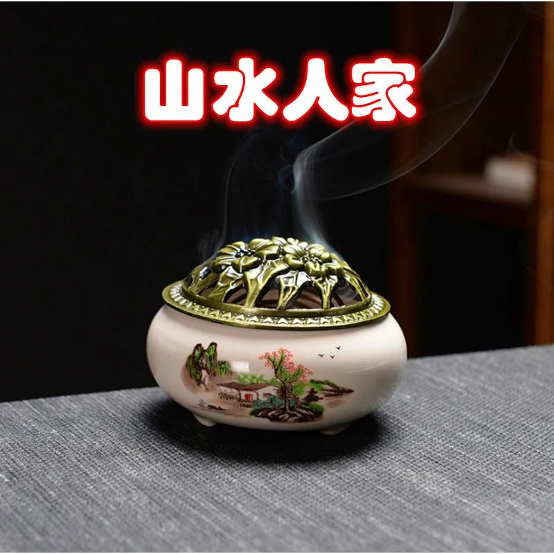 Ceramic incense burner with white glaze, floral print, and ornate gold lid