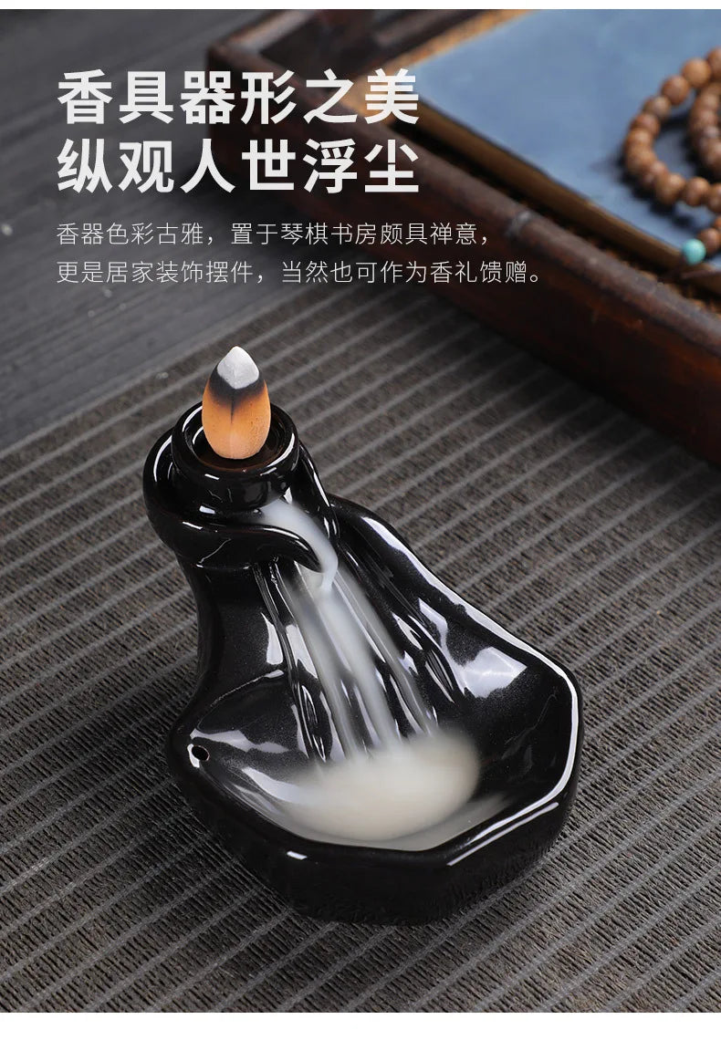 Black glossy backflow incense tower burner with cone incense and swirling smoke