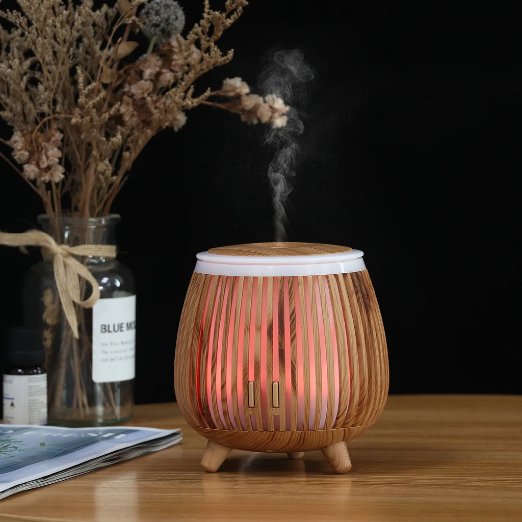 Light wood-grain aroma diffuser humidifier with red LED glow and visible mist