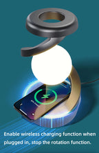 Wireless charging RGB lamp with bright white orb, metal top, and smartphone on base