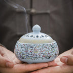 Sky blue enamel lotus incense burner with open base and rolled incense coil