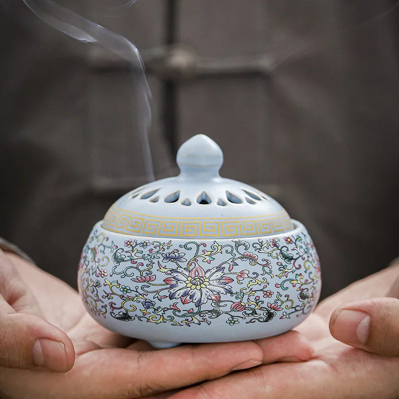 Sky blue enamel lotus incense burner with open base and rolled incense coil