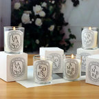 Glass jar scented candles with labels; multiple scents with flames on display