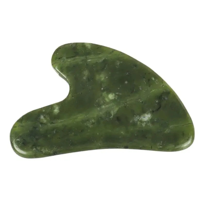 Heart-shaped jade gua sha massager, green polished Xiuyan jade close-up