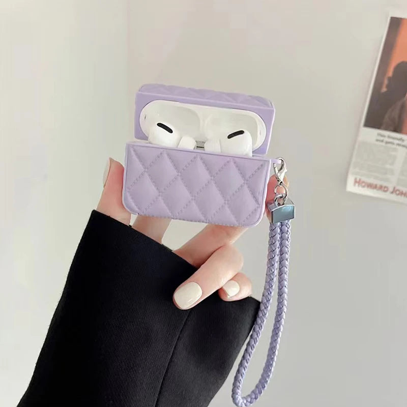Lavender quilted leather AirPods case with lanyard strap, earbuds visible