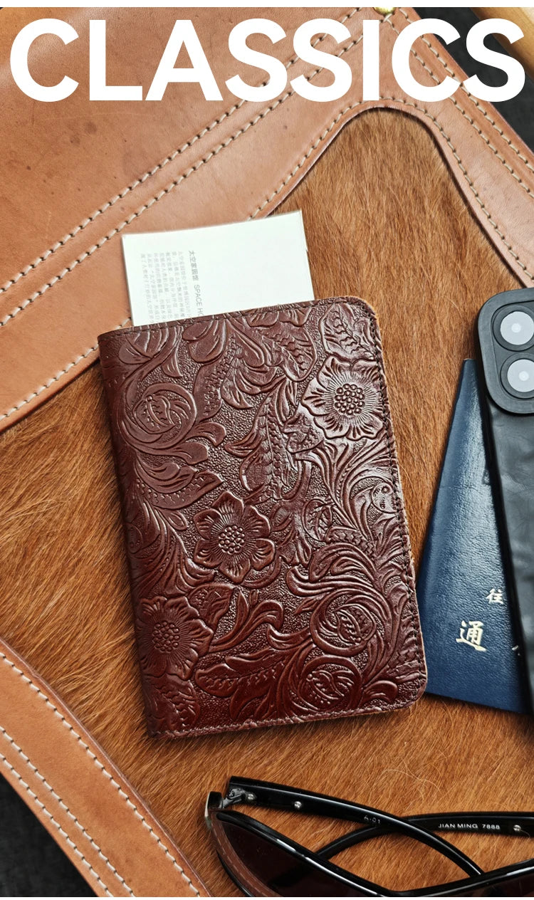 Dark brown embossed leather travel folio with floral pattern and card slot on front.