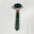 Deep forest green jade roller massager with rose-gold frame