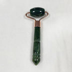 Deep forest green jade roller massager with rose-gold frame