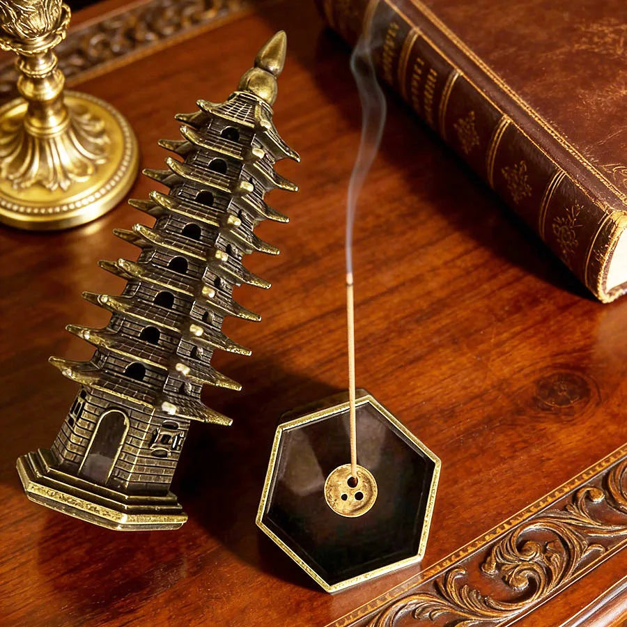 Tower incense stand with smoke hole top, dark tiers and gold accents