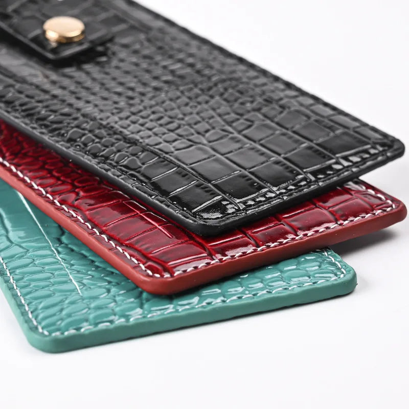 Stacked croc-texture passport covers with stitched edges in Midnight Black, Burgundy, Forest Green