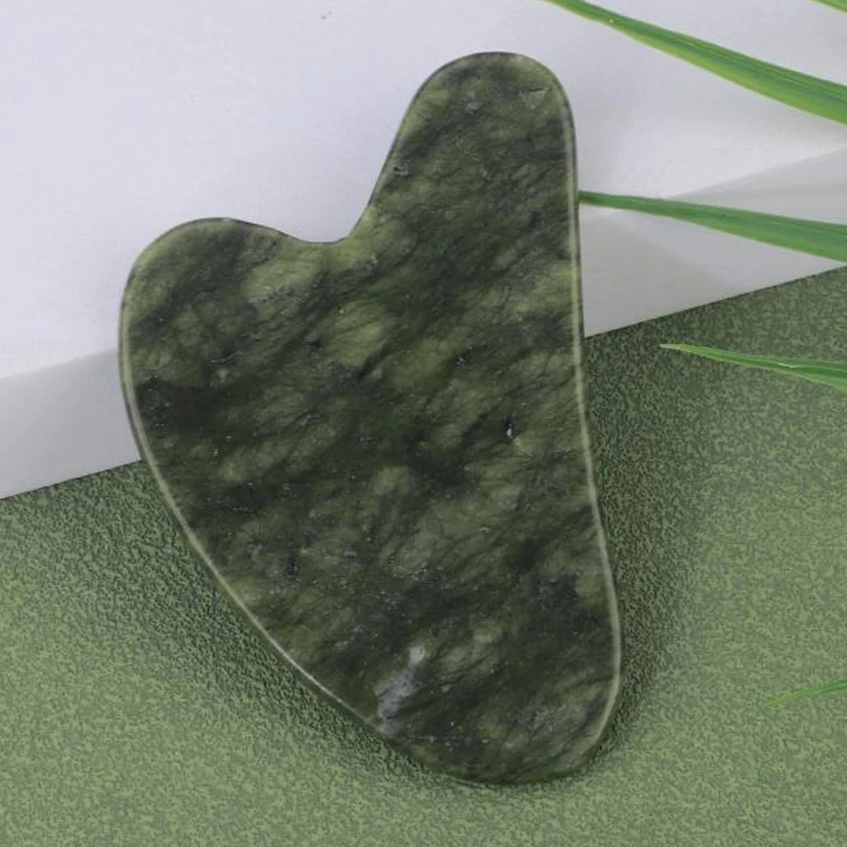 Forest Jade Jade face & body roller, dark green heart-shaped stone
