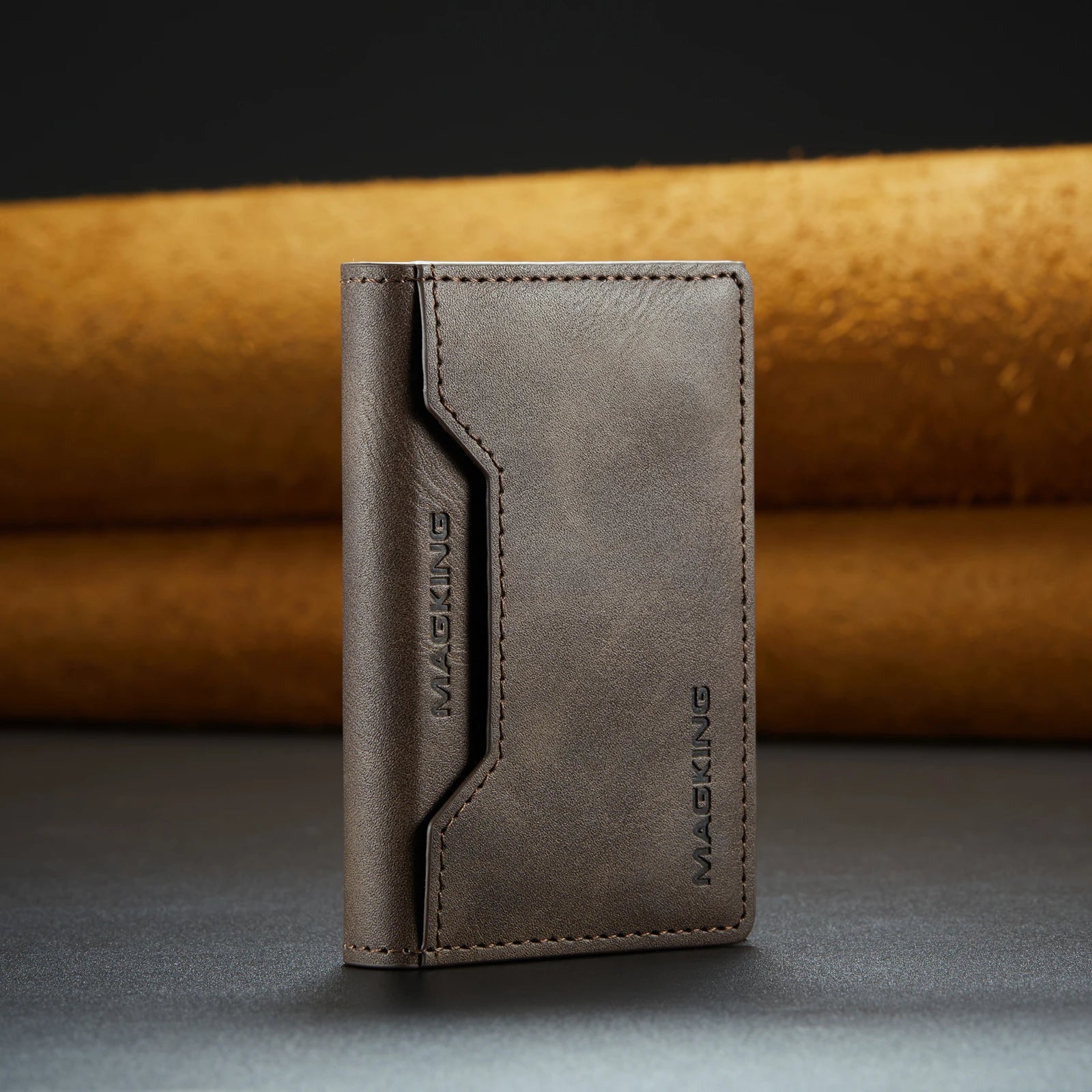 Grey slim leather wallet with stitched front panel and brand logo.