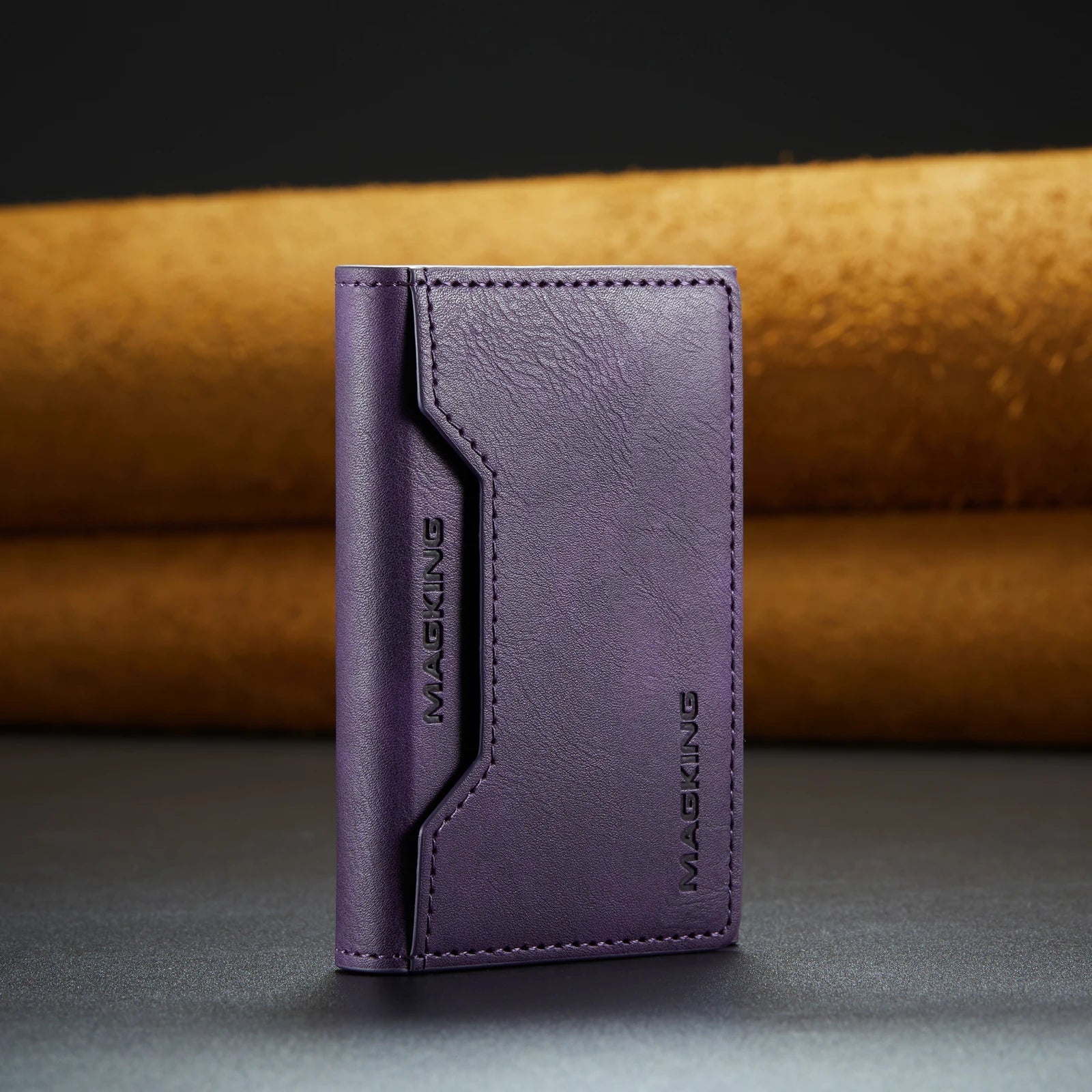 Purple slim leather wallet with stitched front panel and brand logo.