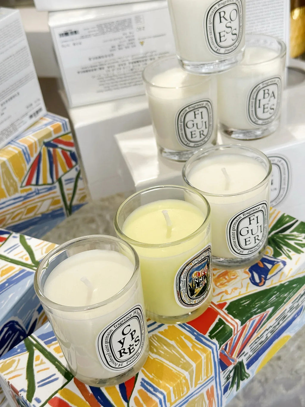 French Botanical scented candle jars in white and pale yellow with printed labels