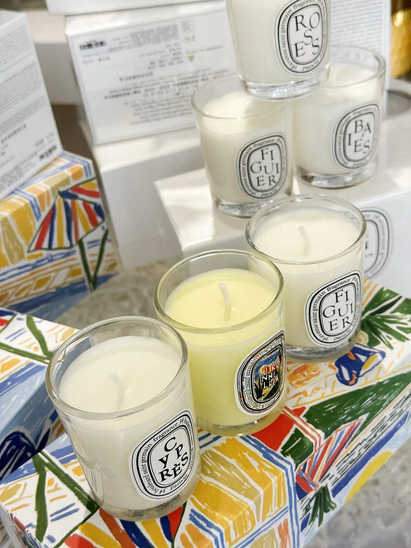 French Botanical scented candle jars in white and pale yellow with printed labels