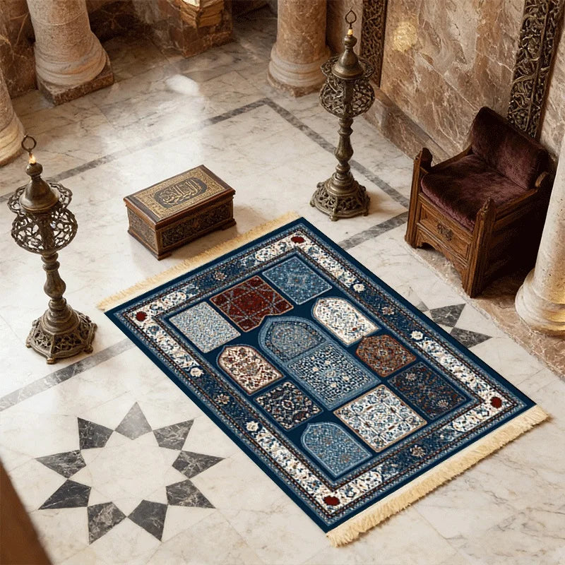 Islamic-style prayer mat with dark-blue border, multi-panel arches, and off-white fringe