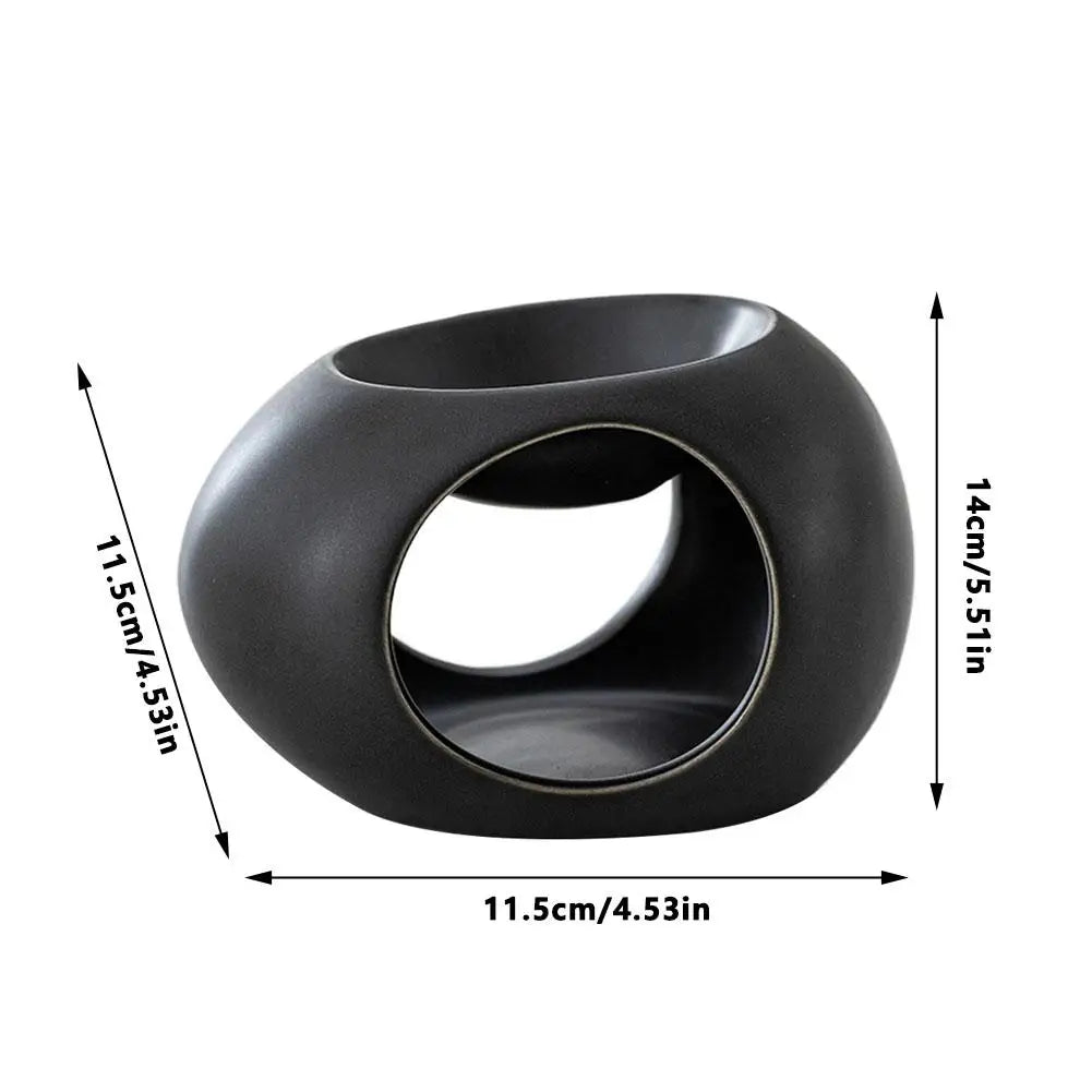Black ceramic aroma burner, 11.5cm wide and 14cm tall, oval cutout